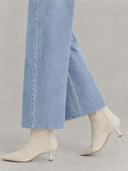 Side slit and raw hem detail of ZPIUO light-blue cropped jeans